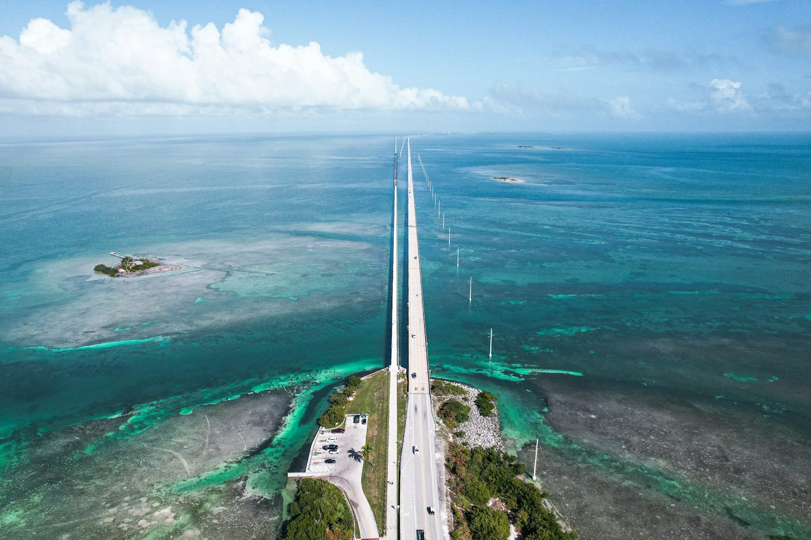 An aerial view of a lighthouse in the middle of the ocean