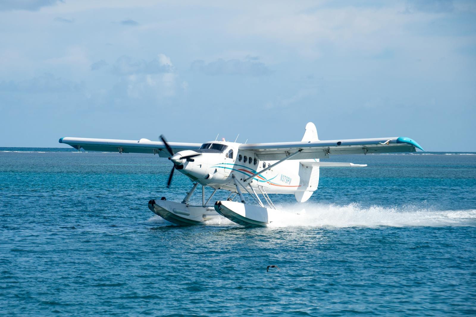 Seaplane gracefully landing on turquoise ocean waters in Key West, Florida.