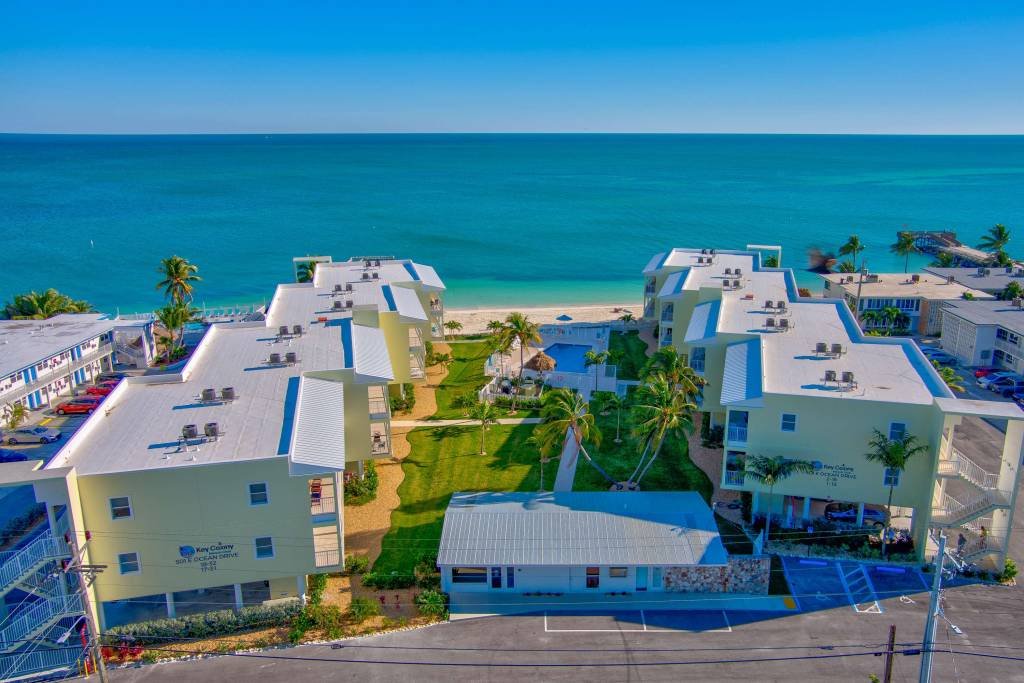 Beachfront condos overlooking the ocean with clear blue skies
