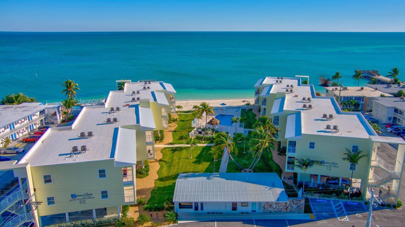 Beachfront condos overlooking the ocean with clear blue skies