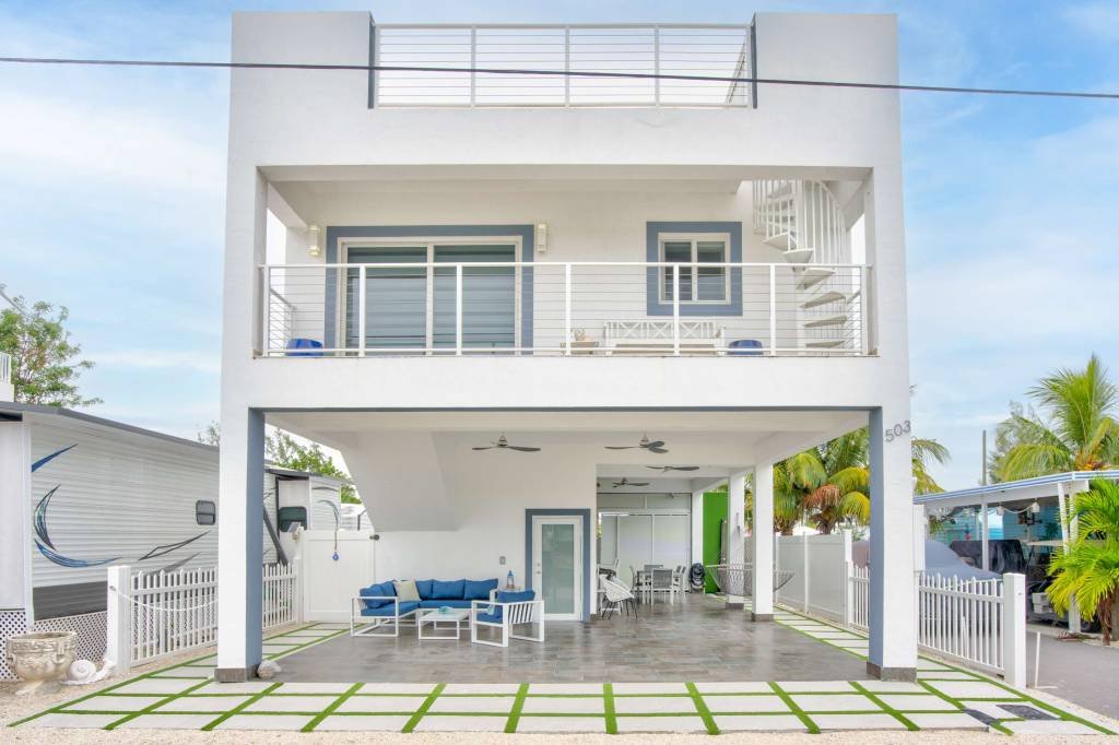 Modern two-story home with outdoor patio and garden design